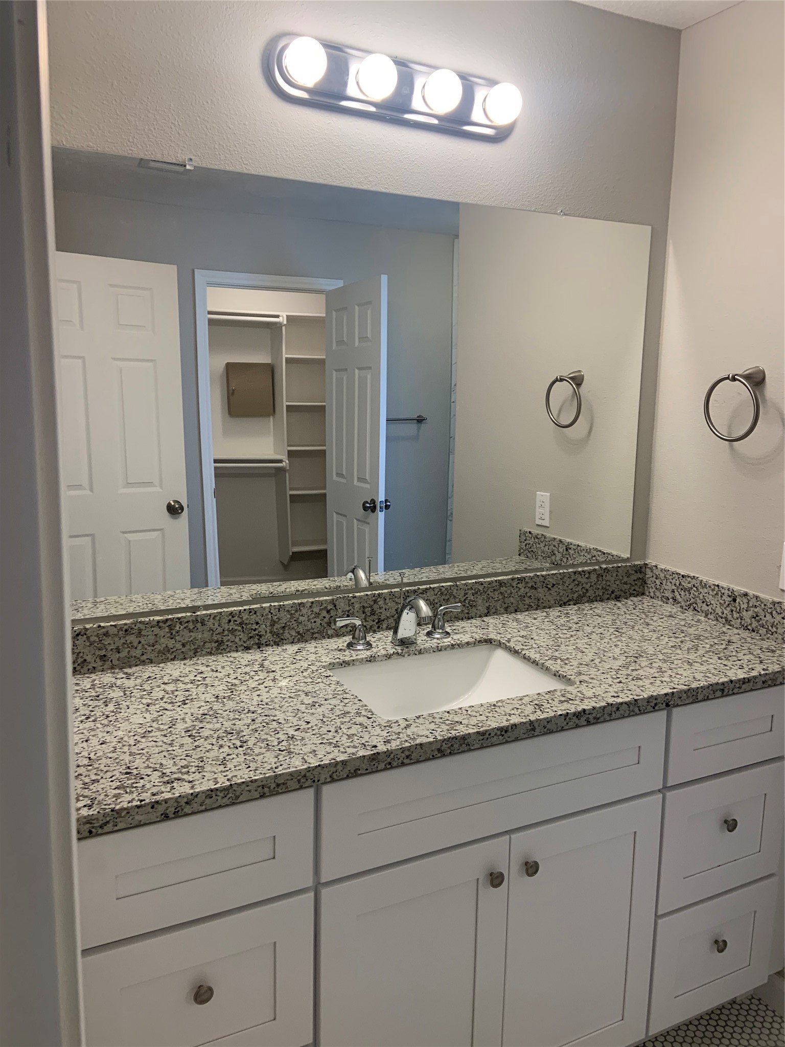 10978 Youpon Street Cleveland, TX 77328 - Photo 17 of 24 a bathroom with a granite countertop sink and a mirror