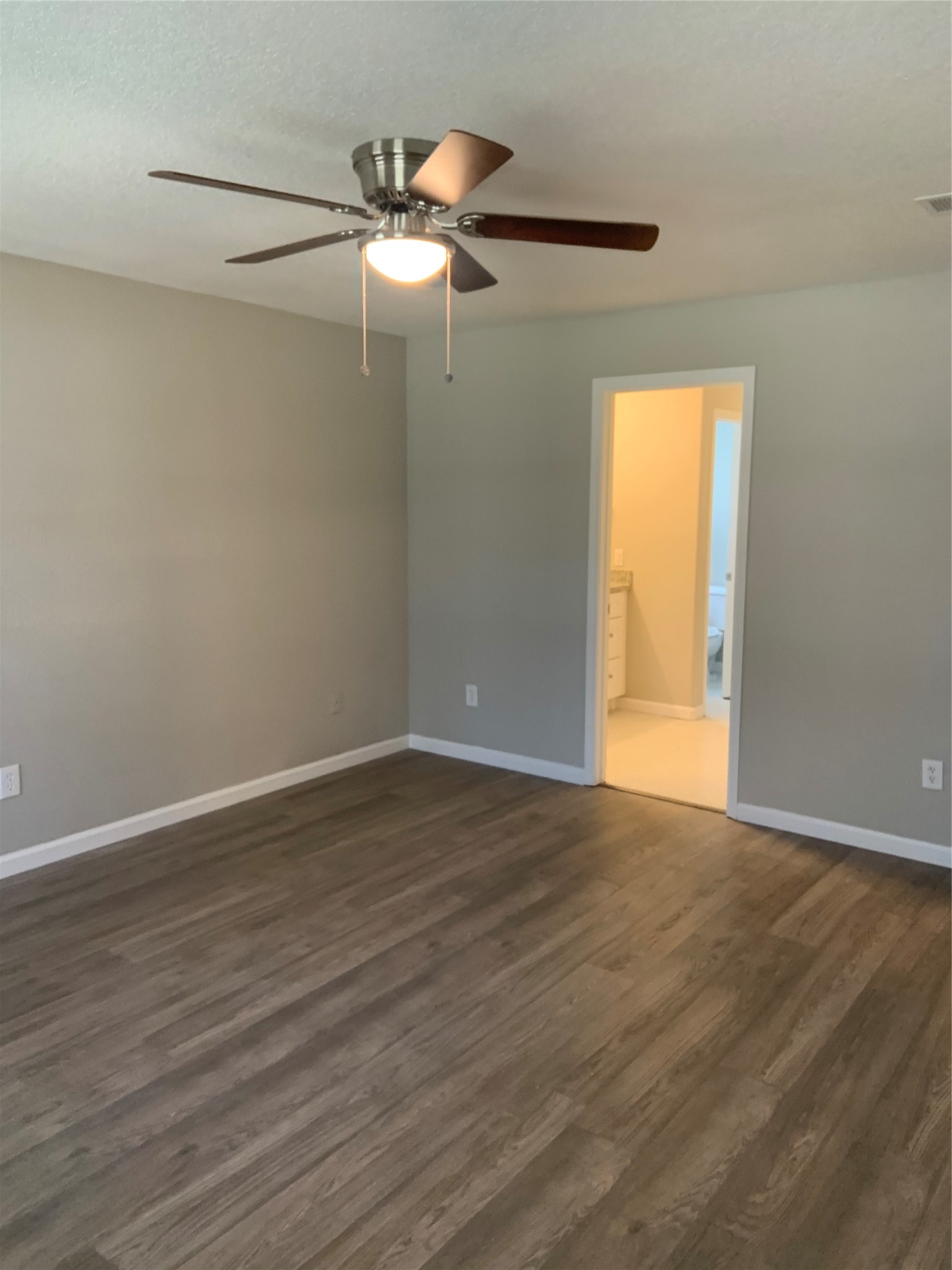 10978 Youpon Street Cleveland, TX 77328 - Photo 22 of 24 a view of an empty room with wooden floor and a window