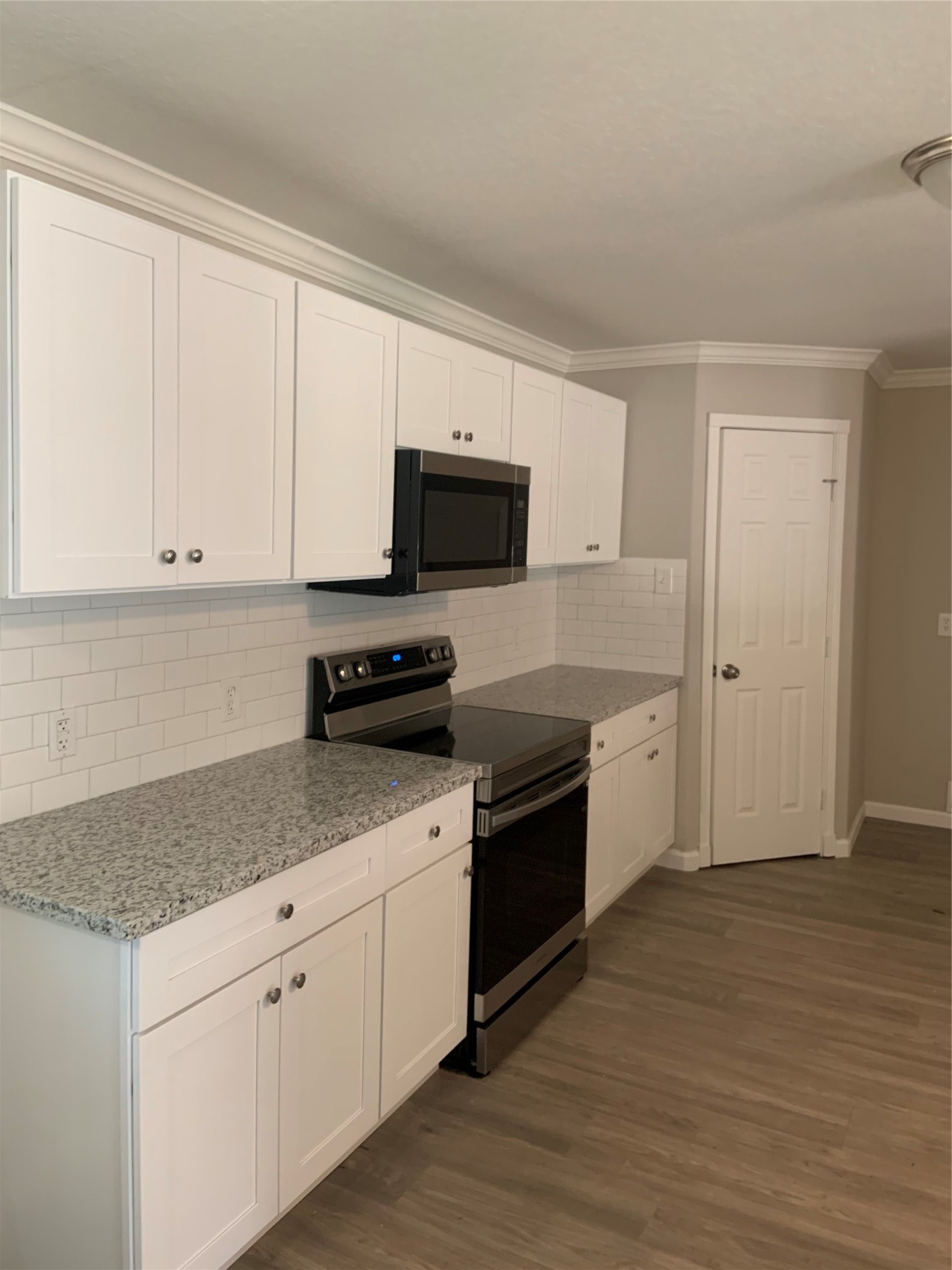 10978 Youpon Street Cleveland, TX 77328 - Photo 8 of 24 a kitchen with stainless steel appliances granite countertop a stove a sink and a microwave