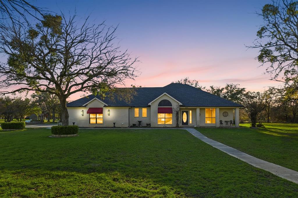 a front view of house with yard and green space