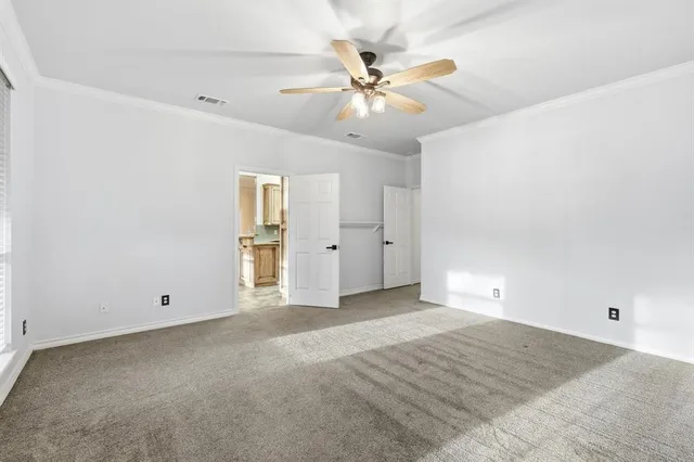 a large white kitchen with a stove a sink dishwasher a refrigerator and a fireplace