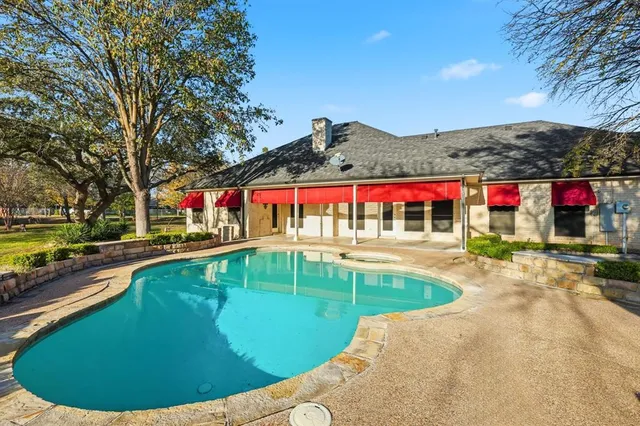 a view of a swimming pool and trees in the background