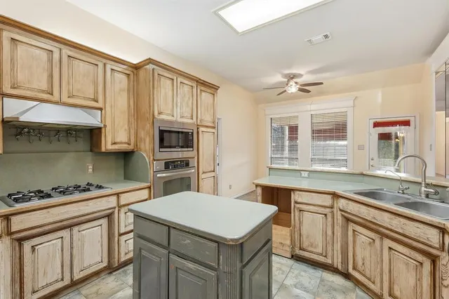 a kitchen with a sink stove and cabinets