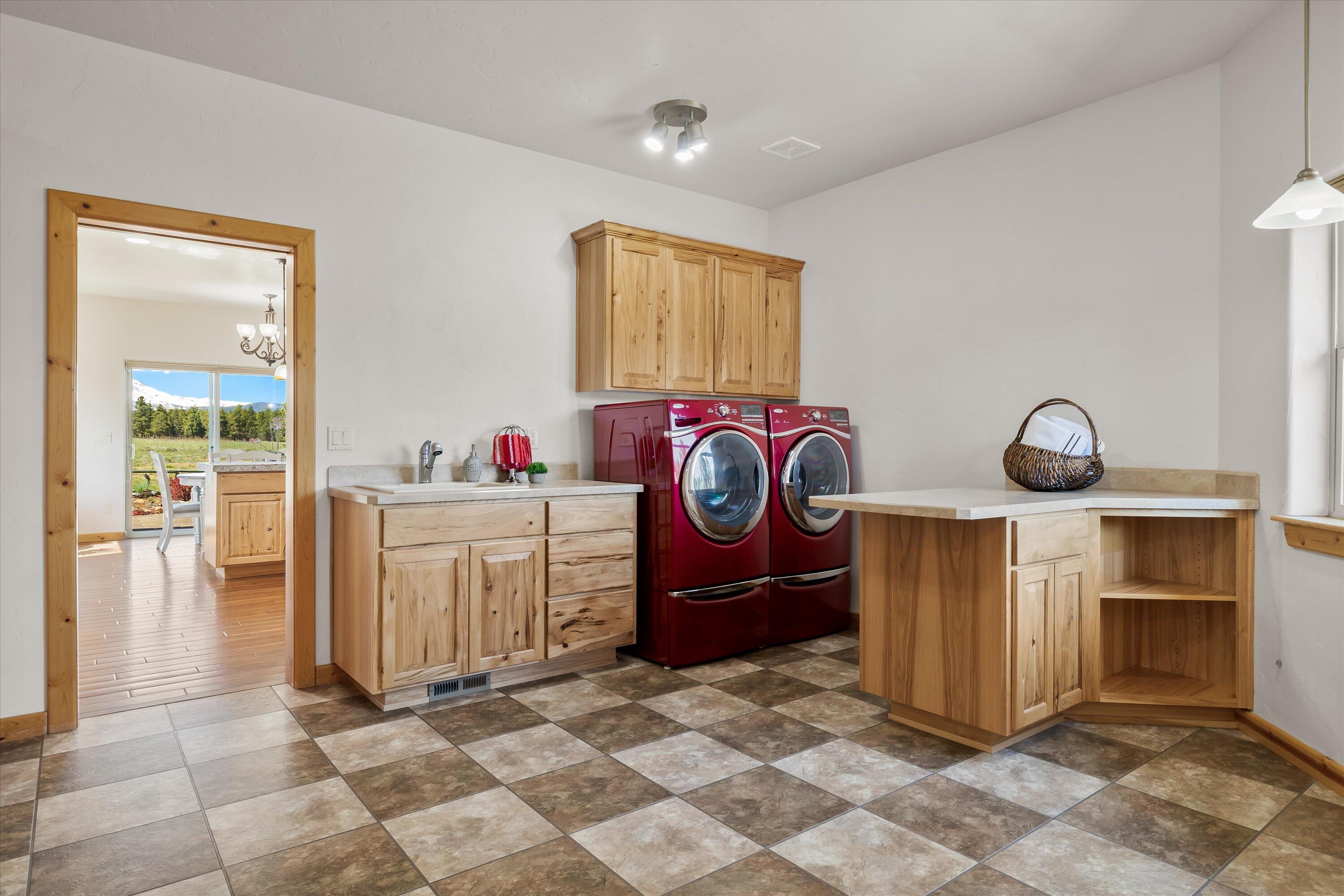 69125 Hurtley Ranch Road Sisters, OR 97759 - Photo 45 of 77 Enormous laundry and mud room also includes an especially convenient 1/2 bath near the outdoor entrances.