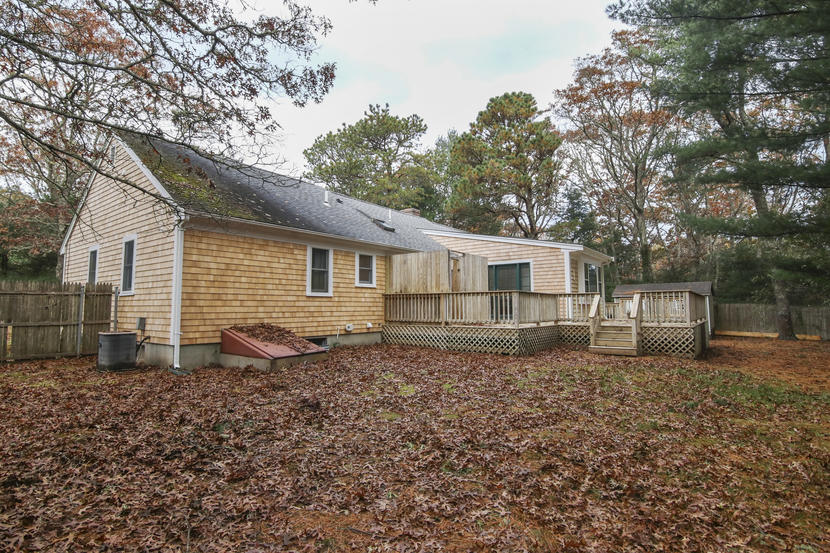 18 Sandy Valley Road Marstons Mills, MA 02648 - Photo 23 of 25 a backyard of a house with table and chairs