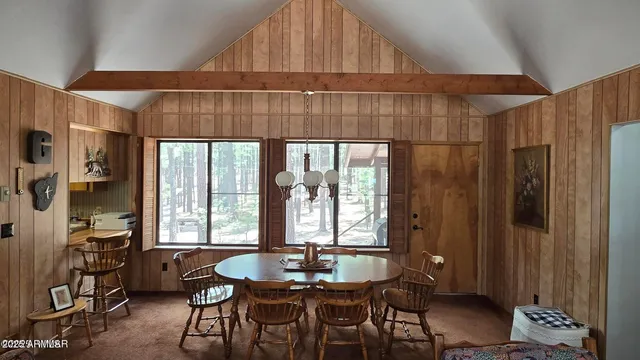 a dining room with furniture and window
