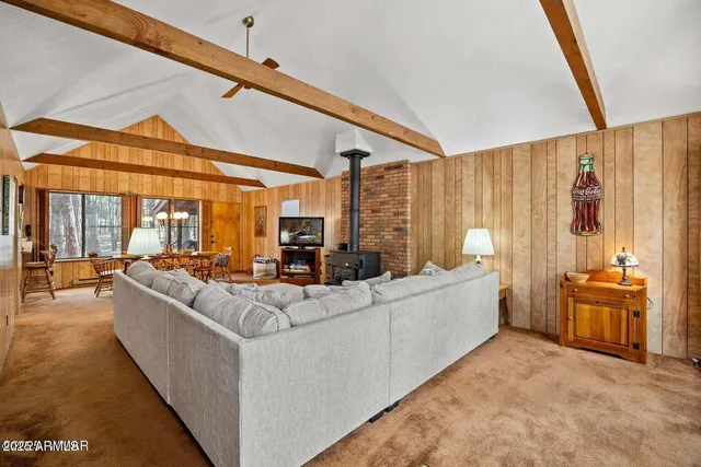 a living room with furniture a lamp and a floor to ceiling window