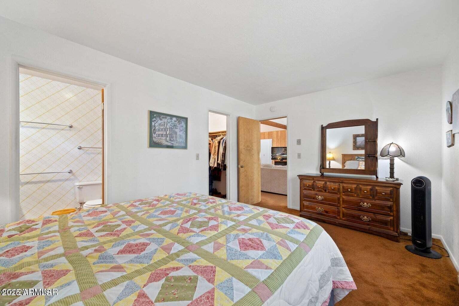 4 County Road 2089 Alpine, AZ 85920 - Photo 28 of 48 a bedroom with a bed and dresser with mirror