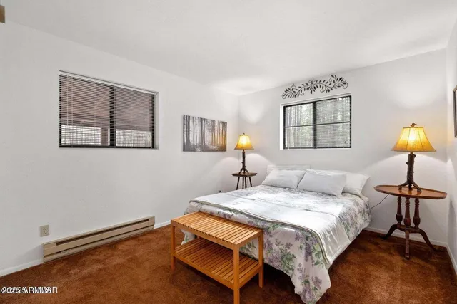 a bedroom with a bed and painting on the wall