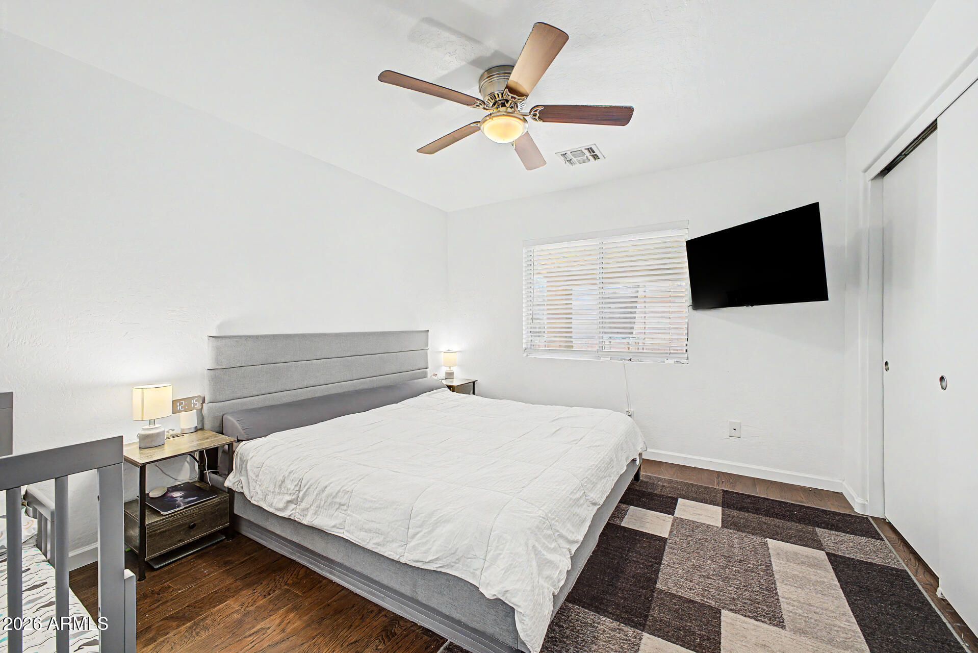 12008 West Larkspur Road El Mirage, AZ 85335 - Photo 11 of 25 a bedroom with a bed and a flat screen tv