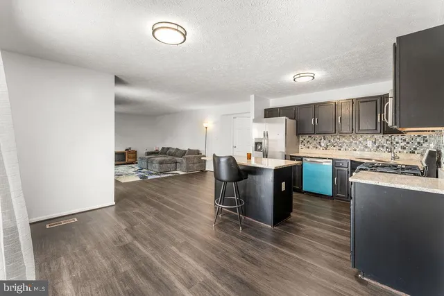 a kitchen with a sink cabinets and wooden floor