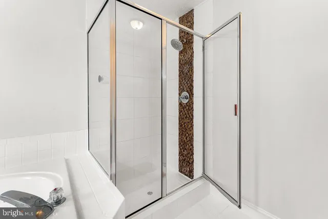 a bathroom with a shower and a glass door