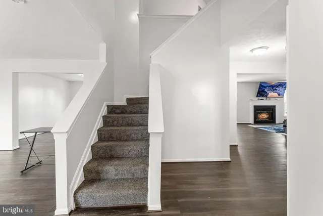 a view of entryway and hall with wooden floor