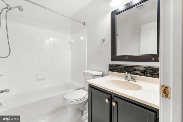 a bathroom with a sink toilet vanity and shower
