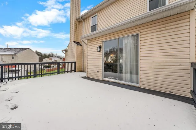 a view of a house with a wooden fence