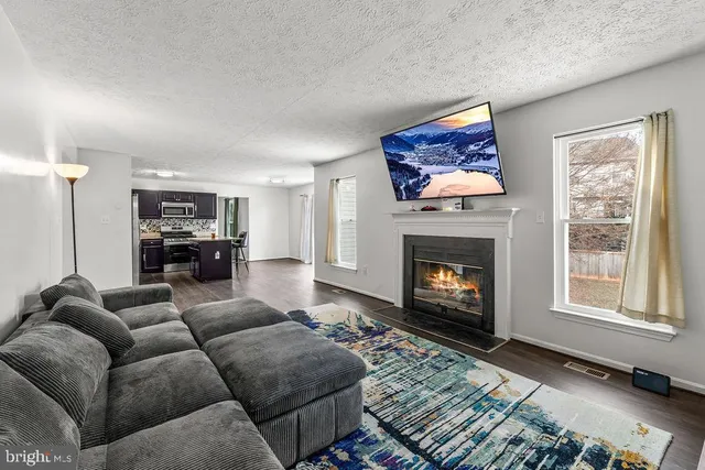 a living room with furniture a window and a fireplace