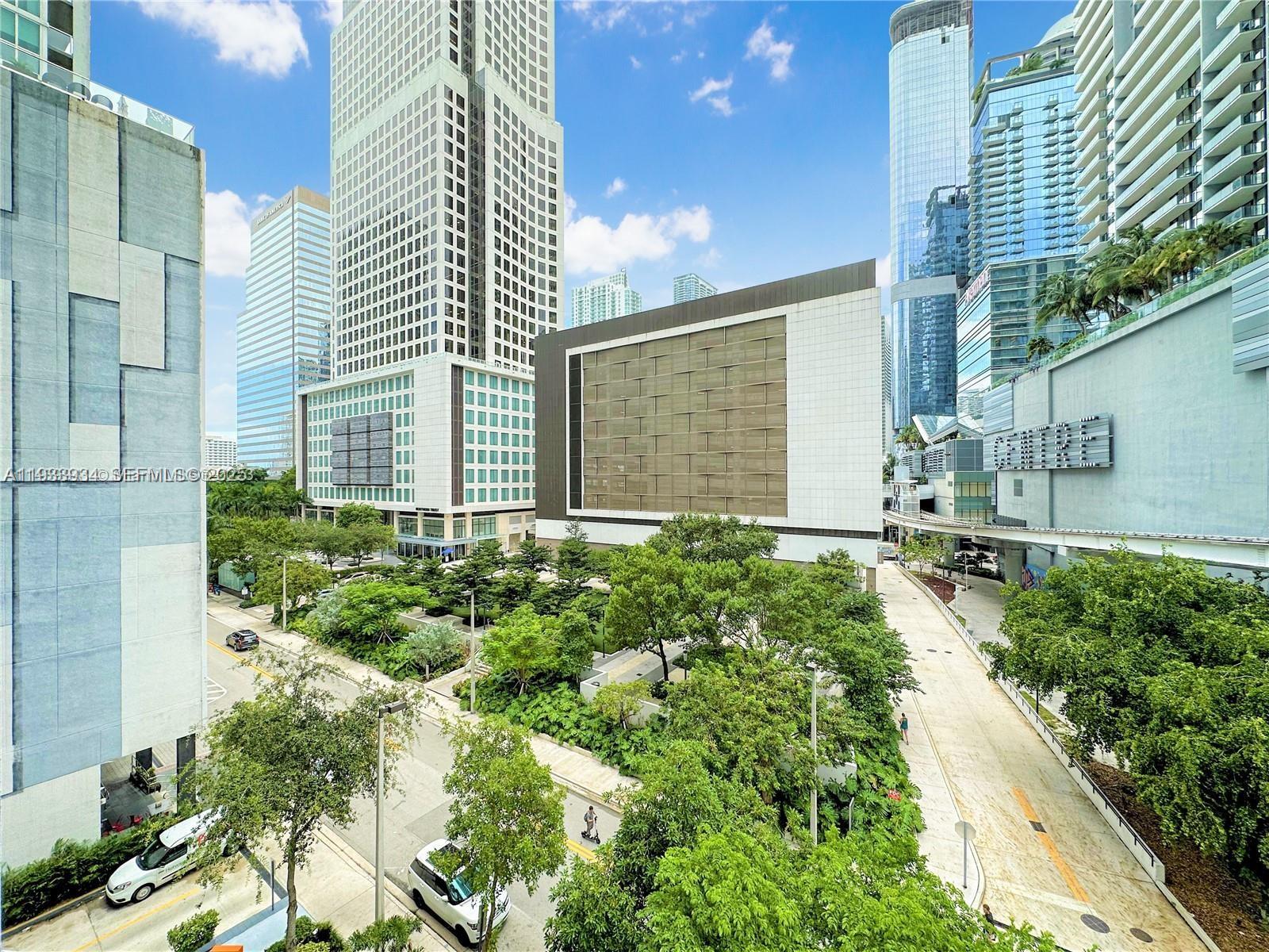a view of a house with a yard and potted plants