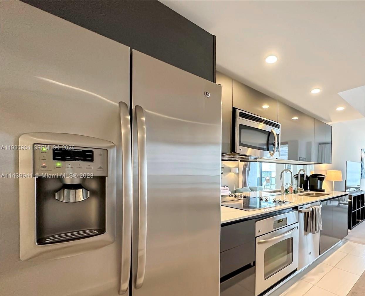 31 Southeast 6th Street, Unit 703 Miami, FL 33131 - Photo 2 of 16 a kitchen with stainless steel appliances granite countertop a refrigerator and a stove top oven