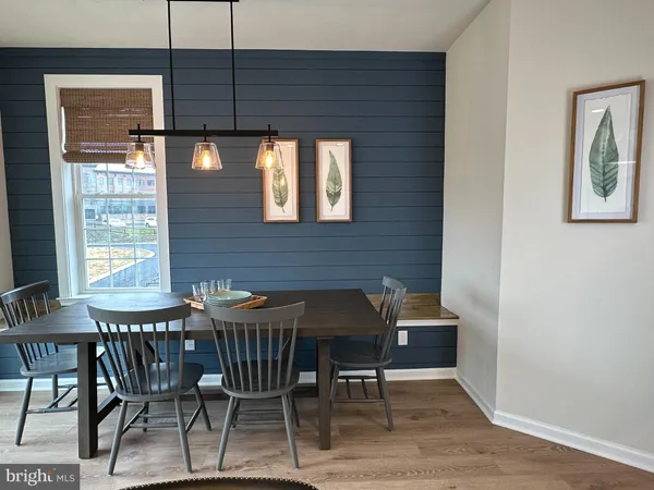 a dining room with a table and chairs