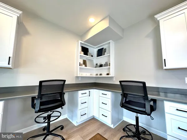 a kitchen with a refrigerator and a stove top oven