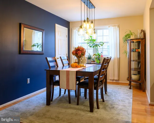 a view of a dining room with furniture and chandelier