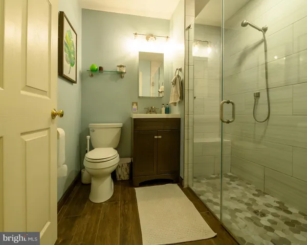 a bathroom with a toilet and a shower