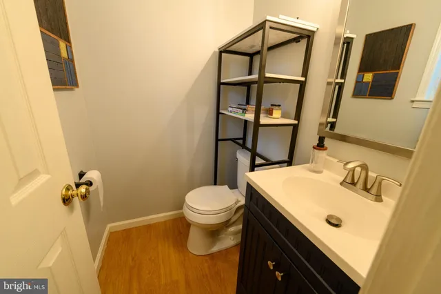 a bathroom with a sink toilet and mirror