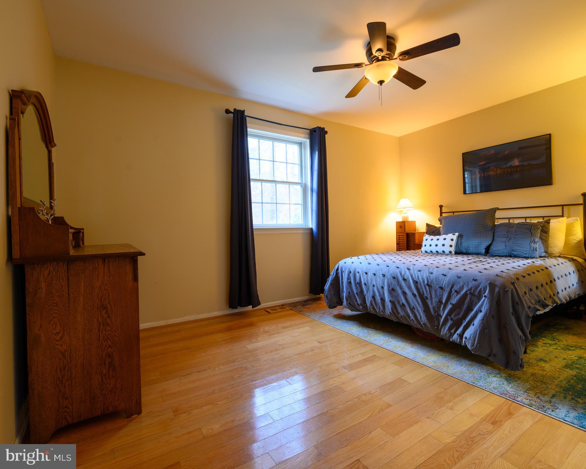 653 McKendimen Road Shamong, NJ 08088 - Photo 7 of 13 a bedroom with a bed a dresser with wooden floor