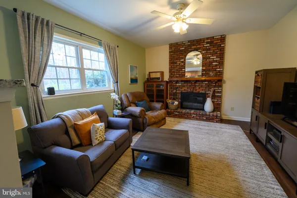 a living room with fireplace furniture and a flat screen tv