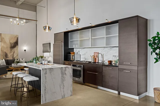 a kitchen with stainless steel appliances kitchen island granite countertop a sink and cabinets