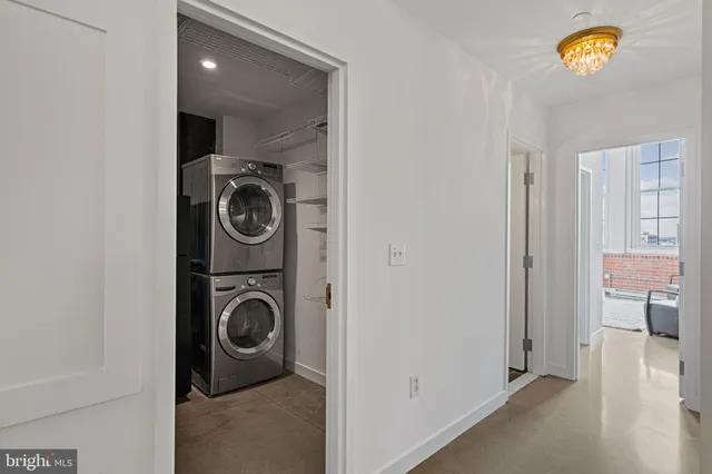 a view of a hallway with washer and dryer