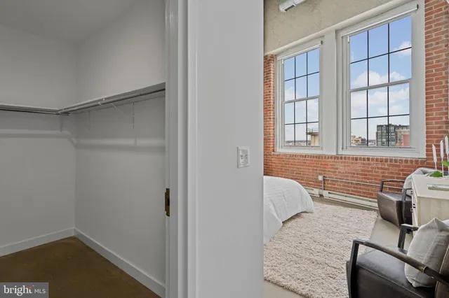a bathroom with a granite countertop sink and washing machine