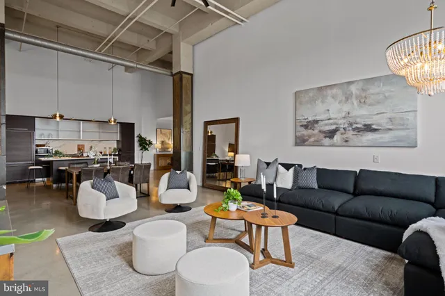 a living room with furniture and a chandelier