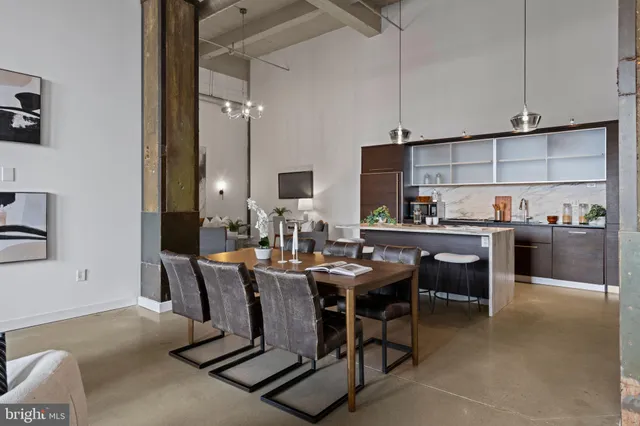 a room with stainless steel appliances kitchen island granite countertop furniture and a view of kitchen