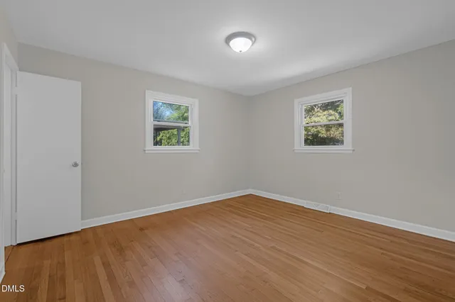 a view of wooden floor and windows in a room