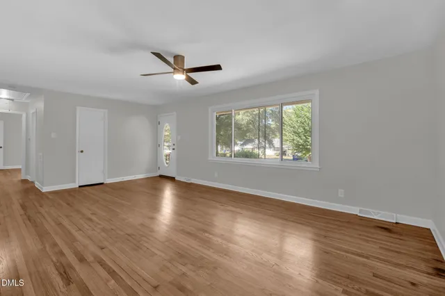 wooden floor in an empty room with a window