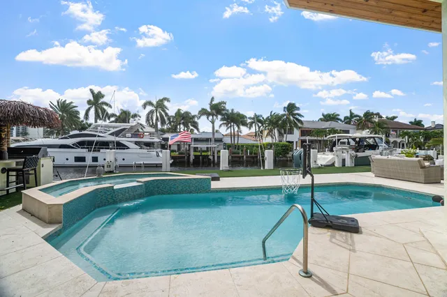 a view of a patio with couches and table under an umbrella