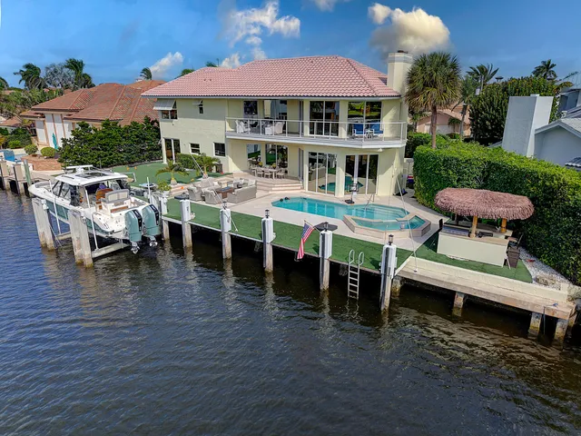a view of a house with backyard porch and sitting area