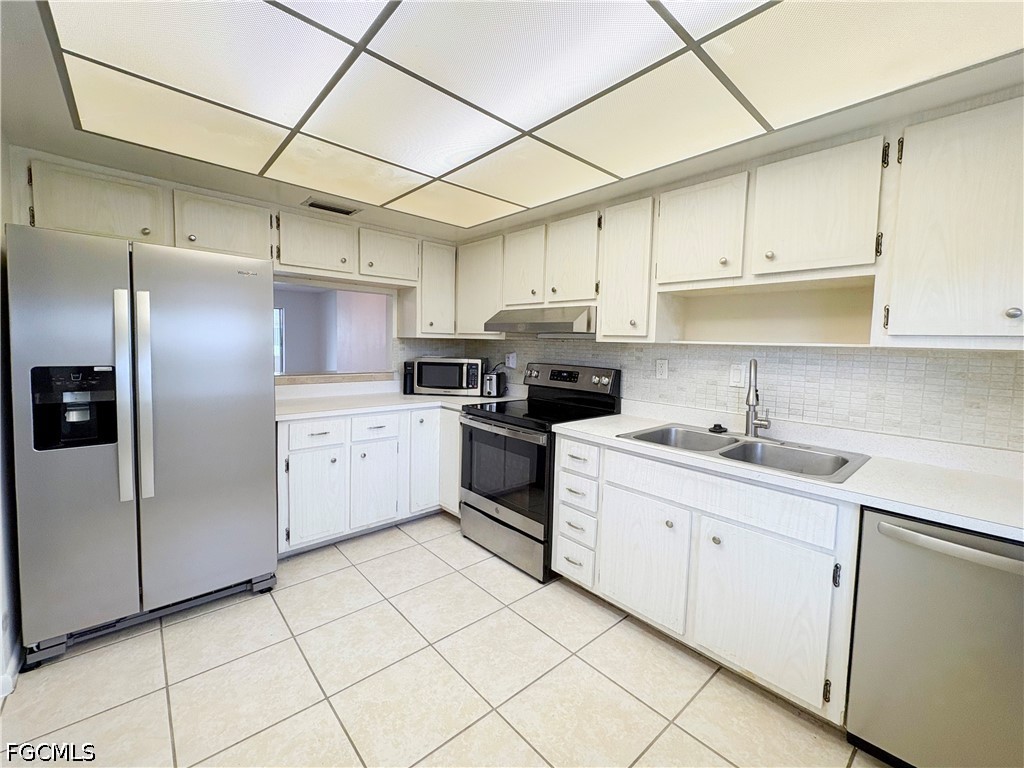 1830 Brantley Road, Unit I7 Fort Myers, FL 33907 - Photo 7 of 34 a kitchen with cabinets a sink and white stainless steel appliances