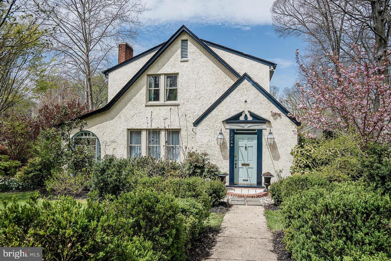 a front view of a house with yard and green space