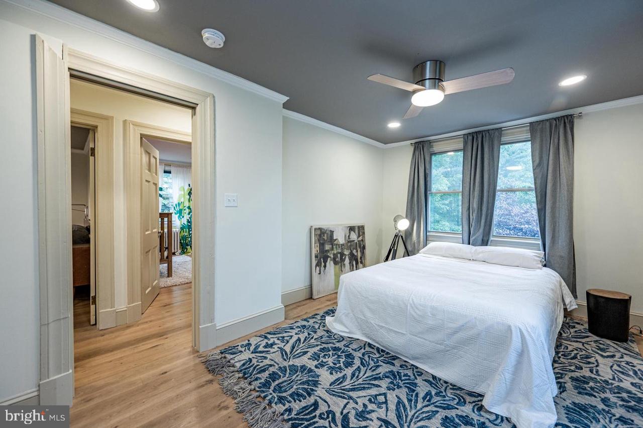 2244 Crest Road Baltimore, MD 21209 - Photo 33 of 54 a bedroom with a large bed and a chandelier