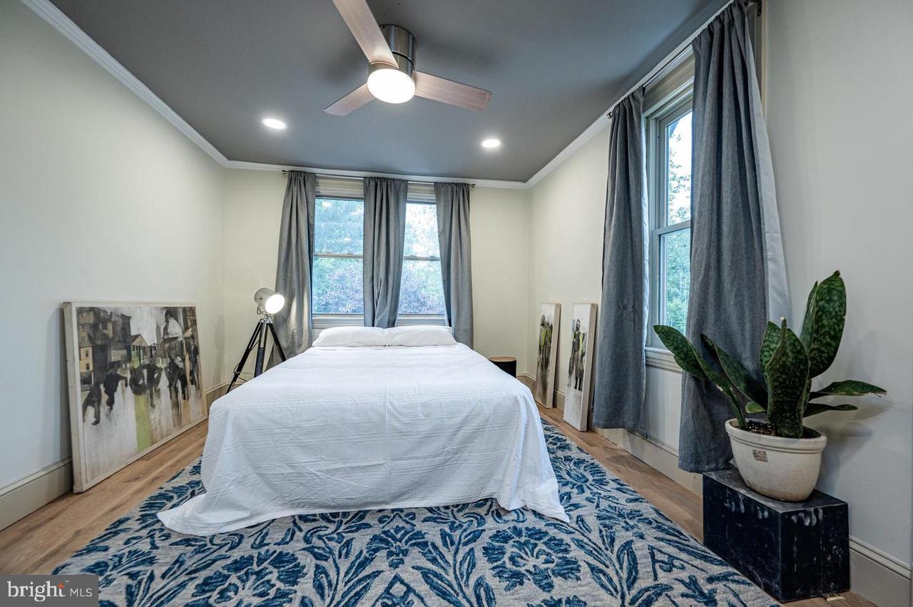 2244 Crest Road Baltimore, MD 21209 - Photo 34 of 54 a bedroom with a large bed and a potted plant