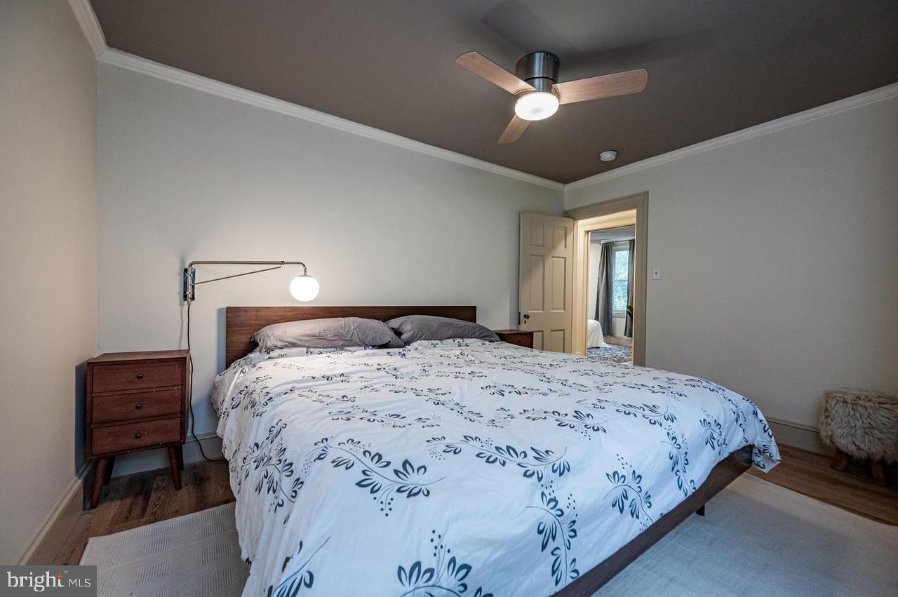 2244 Crest Road Baltimore, MD 21209 - Photo 39 of 54 a bedroom with a large bed and a chandelier