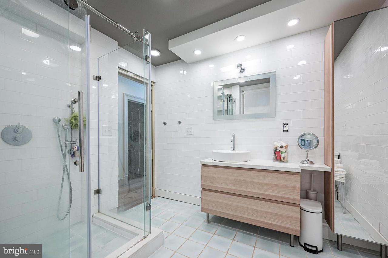 2244 Crest Road Baltimore, MD 21209 - Photo 40 of 54 a bathroom with a sink mirror and shower