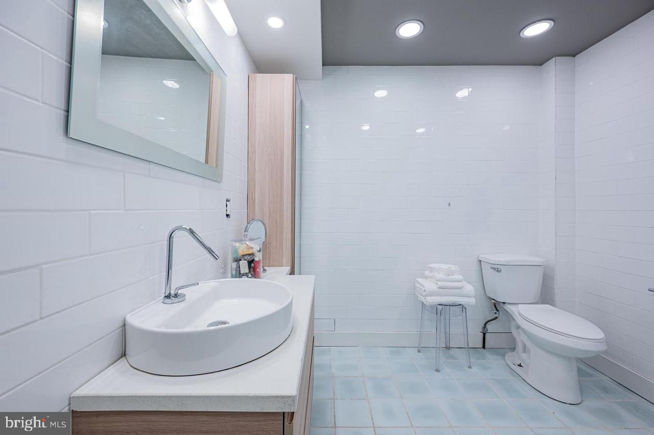 2244 Crest Road Baltimore, MD 21209 - Photo 41 of 54 a bathroom with a toilet a sink and a mirror