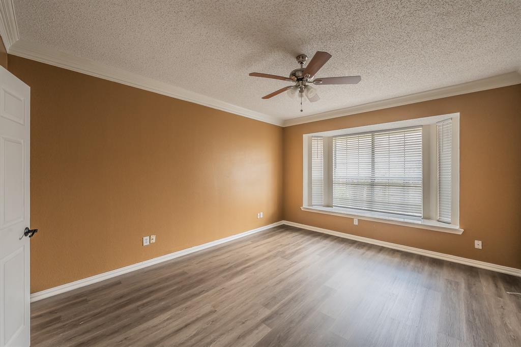 2643 Garden Ridge Lane Arlington, TX 76006 - Photo 18 of 40 a view of empty room with wooden floor and fan