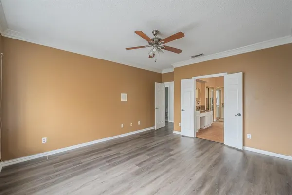 a view of a big room with wooden floor and a ceiling fan