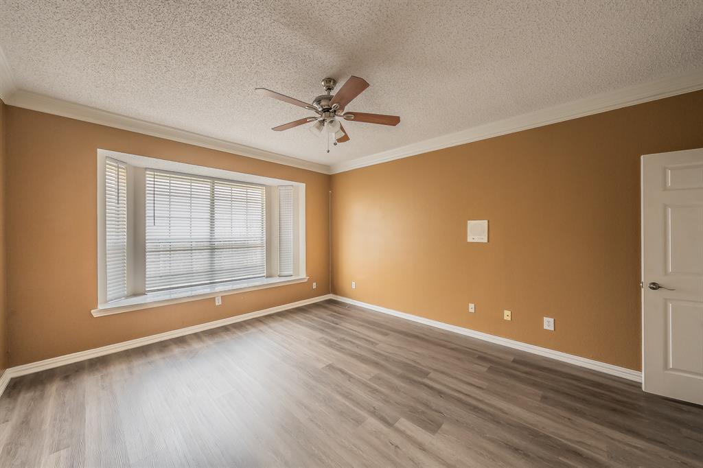 2643 Garden Ridge Lane Arlington, TX 76006 - Photo 21 of 40 a view of an empty room with a window and wooden floor