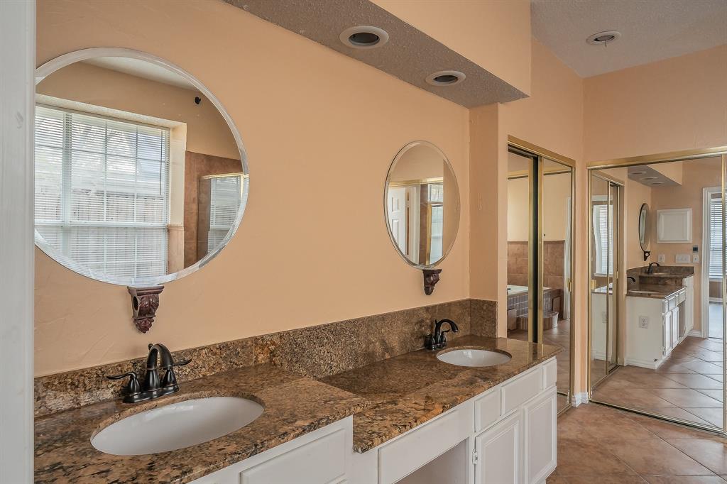 2643 Garden Ridge Lane Arlington, TX 76006 - Photo 22 of 40 a bathroom with a granite countertop double vanity sink and a mirror