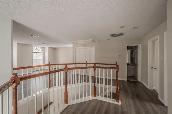a view of hallway with wooden floor